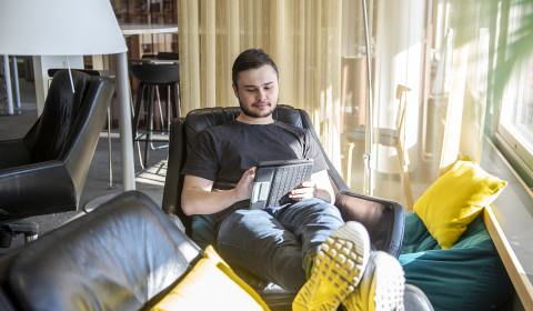 Young man working with a tablet.